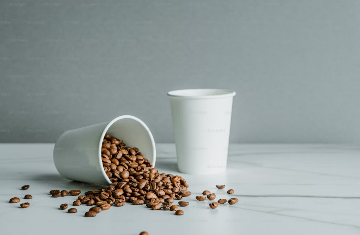 Coffee Beans falling out of a cup
